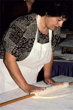 Image of Ivanka Husovic rolls out dough for pita