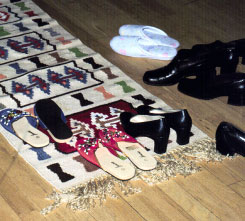 Image of Shoes on rug; Bosnians remove their shoes before entering a home