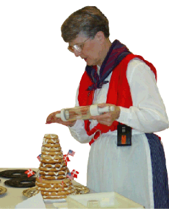 Image of Karma Sorensen as she puts the finishing touches on kransekage, almond-filled pastry baked in rings