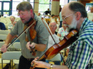 Image of Guy Drollinger and Al Murphy playing twin fiddles